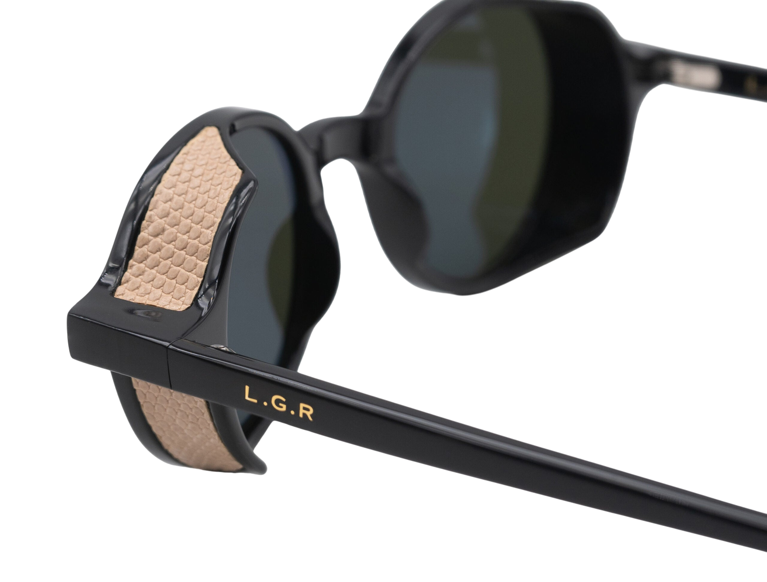 Close-up of black round frame luxury sunglasses with textured beige temple detailing and LGR logo